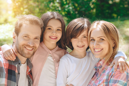 Family together outdoors in the park weekend concept family portrait close-up