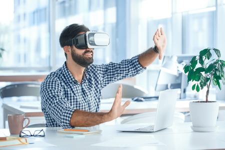 Business man using virtual reality headset in the office