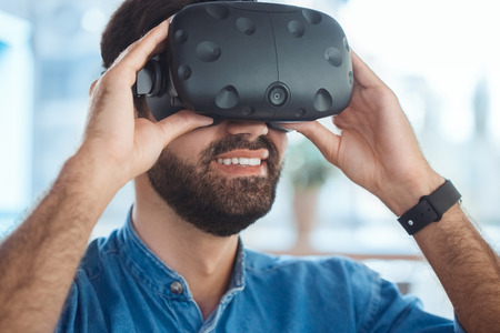 Business man using virtual reality headset in the officeの写真素材