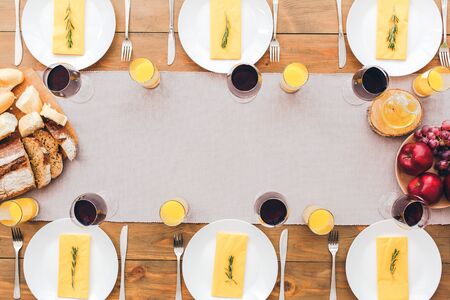 Laid table for lunch. Festive table set for six people. Wooden background top view mock-upの写真素材