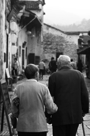 Back view of the an elder couple walking on the streetのeditorial素材