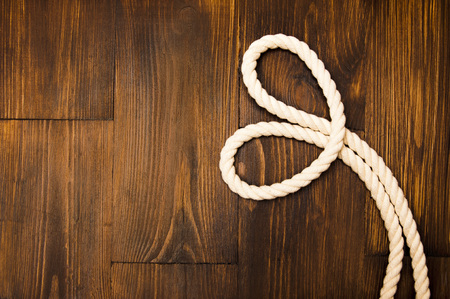 Jute rope in heart shaped on wooden backgroundの写真素材