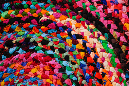 Colorful round african peruvian style rug or woven carpet surface close up. Ethnic and tribal motives. Bright accent in interior or home decorationの写真素材