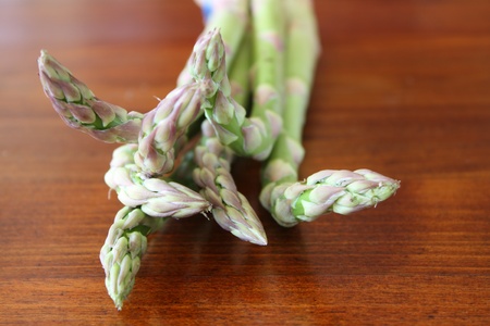 Bundle of asparagus on a wodden surfaceの写真素材