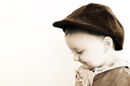 Adorable baby boy wearing a stylish hatの写真素材