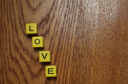 Four blocks on a wooden surface spelling loveの写真素材