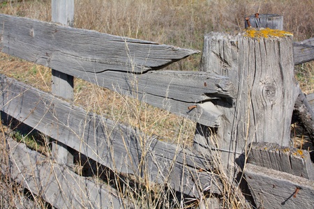 Old wooden fence and post with broken piecesの写真素材