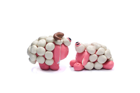 Two plasticine sheep looking at each other.  White background.の写真素材