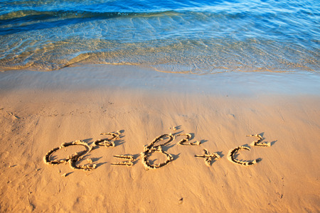 Quadratic equation handwriting on the sand. Sunset on the beach.の写真素材