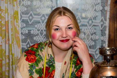 Portrait of a young smiling woman in traditional headscarf.