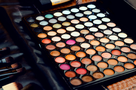 Professional palette of colored eyeshadows. Selective focus on the center.の写真素材