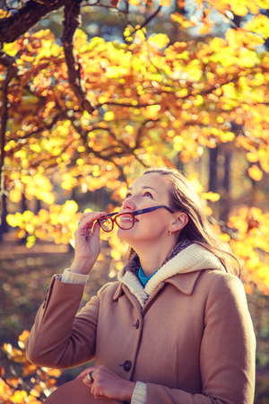 Beautiful smilling woman walking in the autumn park.の写真素材