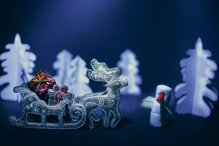 Christmas reindeer driven gifts  in a  snow-covered forest.の写真素材