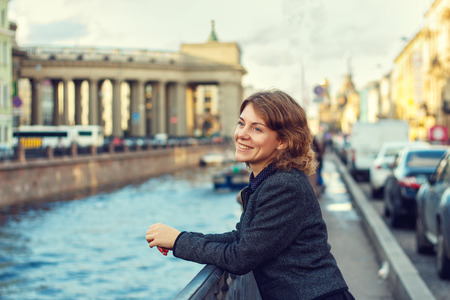 Beautiful woman in the elegant clothes enjoying a walk in the city.の写真素材