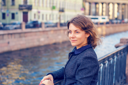 Beautiful woman in the elegant clothes enjoying a walk in the city.の写真素材