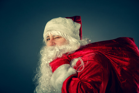 Portrait of Santa Claus. Santa Claus carries a bag with gifts. Christmas Fantasy.の写真素材