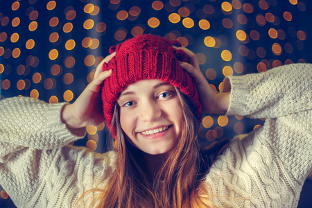 Portrait of a beautiful girl in hat with golden bokeh.の写真素材