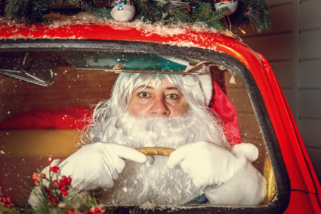 Portrait of Santa Claus. Santa Claus is driving a car. Selective focus.の写真素材