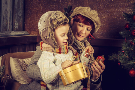 Mother and son in the country house. Christmas card.の写真素材