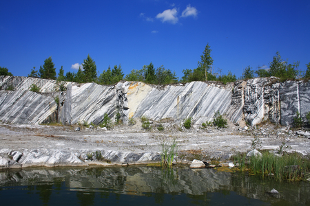 Abandoned marble quarry in Karelia, Russia. Landscape with white rocks and blue sky.の写真素材