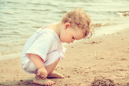 Cute little girl playing in the sea. Beach vacation.の写真素材