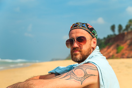 Bearded man on the beach. Tropical summer vacation.の写真素材