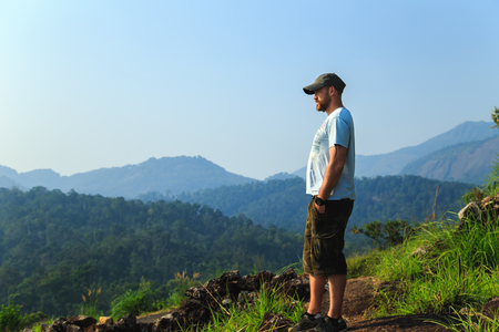 Tourist on the top of the mountain enjoys beautiful view.の写真素材