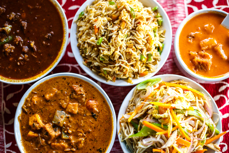 Indian national food - curry chicken, rice, tomato soup, paneer. Top view.の写真素材