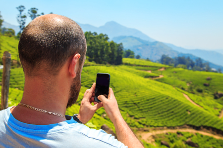 Man inspects the mountain landscape. Munnar, Kerala state, India. Munnar, Kerala state, India.の写真素材