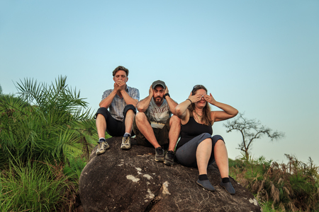 Group of tourists watching the sunset on top of the mountain. Rest after climbing.の写真素材