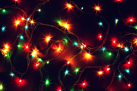 Colorful Christmas lights on a black background. Christmas and New Year's decor.
