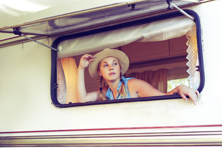 Girl tourist in a camper van in a summer day.の写真素材