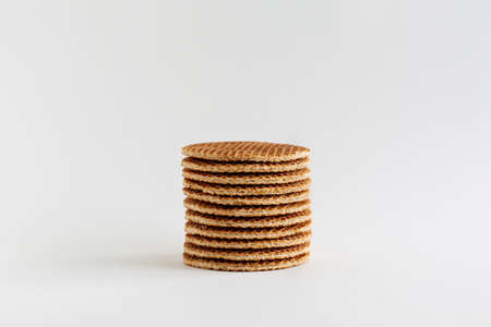 A stack of Dutch stroopwafels (syrup or caramel waffles) on a white background, close upの写真素材