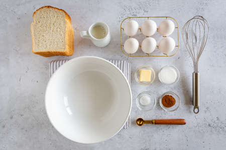 Minimal style flat lay of ingredients for making french toast (or French toast in Dutch) on white gray background, view from aboveの写真素材