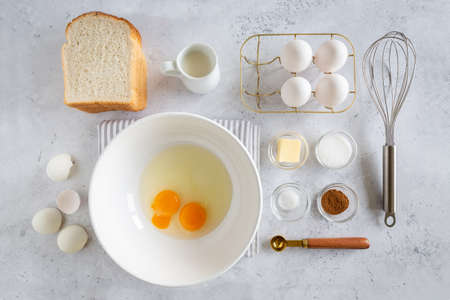 Minimal style flat lay of ingredients for making french toast (or French toast in Dutch) on white...