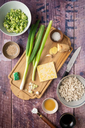 Flat-lay of ingredients for vegan wonton dumplings with tofu and broccoli, recipe for wonton soup, verticalの写真素材
