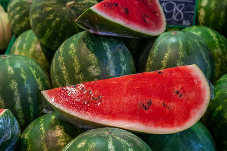 Close-up of a piece of sliced fresh watermelon, sold at a market stall, horizontal