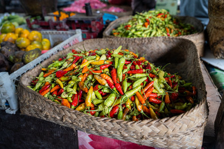 A basket full of fresh Indonesian chili peppers, also called rawit or bird's eye chili, horizontal