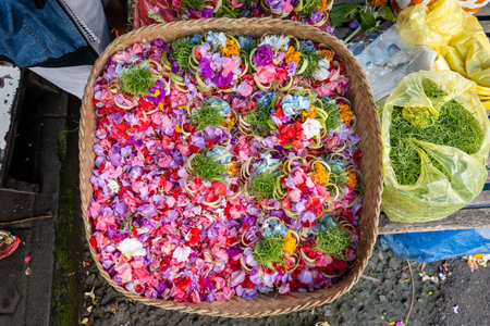 A basket full of flower petals at the market in Bali to be used for offerings, horizontalの素材 [FY310206902306]