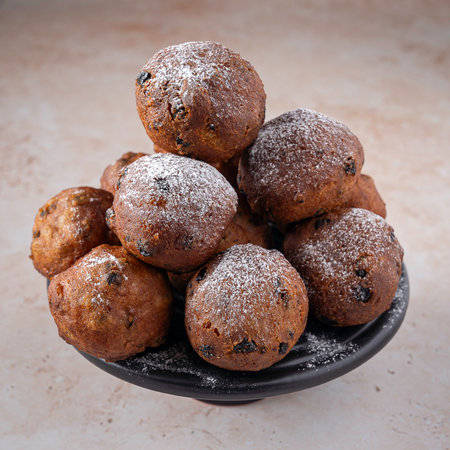 Traditional Dutch oliebollen, served on New Years Evening, light backgroundの写真素材