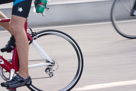 Cyclist in colorful jersey going by