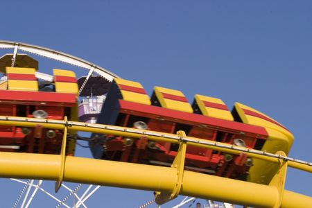 Pacific Park train cars speeding by on the track high up on the boardwalk