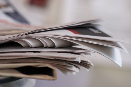 Sunday newspapers on kitchen tableの写真素材
