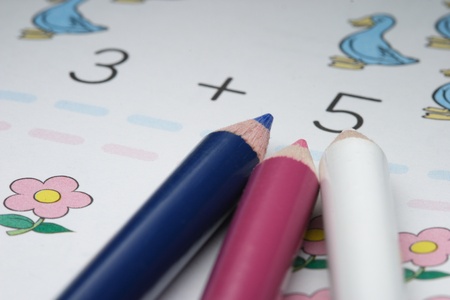 color pencils and children's addition workbookの写真素材