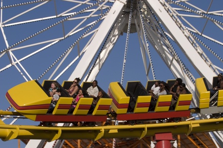 Amusement park train and riders speeding byのeditorial素材