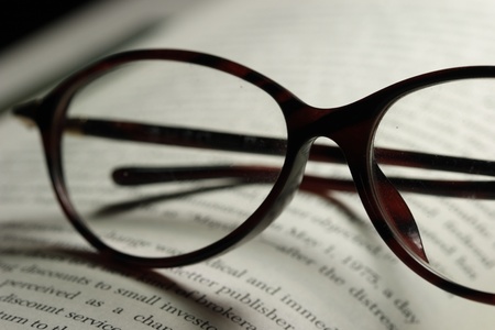 pair of eyeglasses and a novelの写真素材