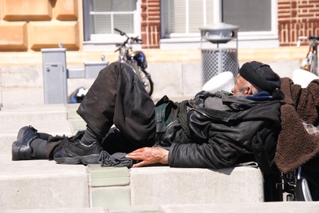 Homeless man sleeping on the sidewalkのeditorial素材