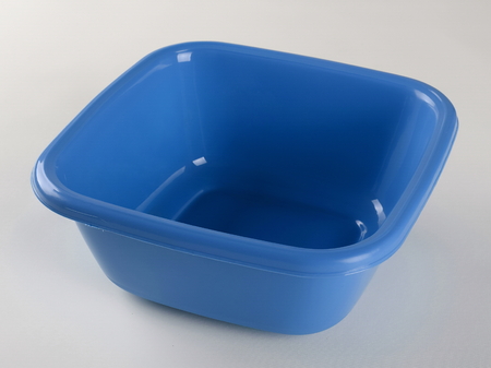 Blue plastic deep bowl, isolated on white backgroundの写真素材