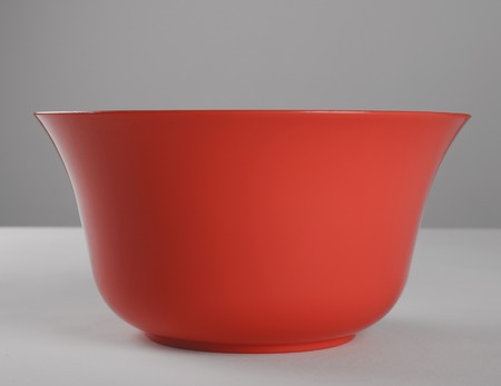 Red round plastic deep dishの写真素材