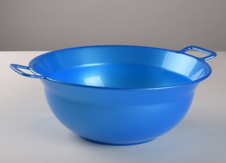 Blue deep plastic bowl with handlesの写真素材